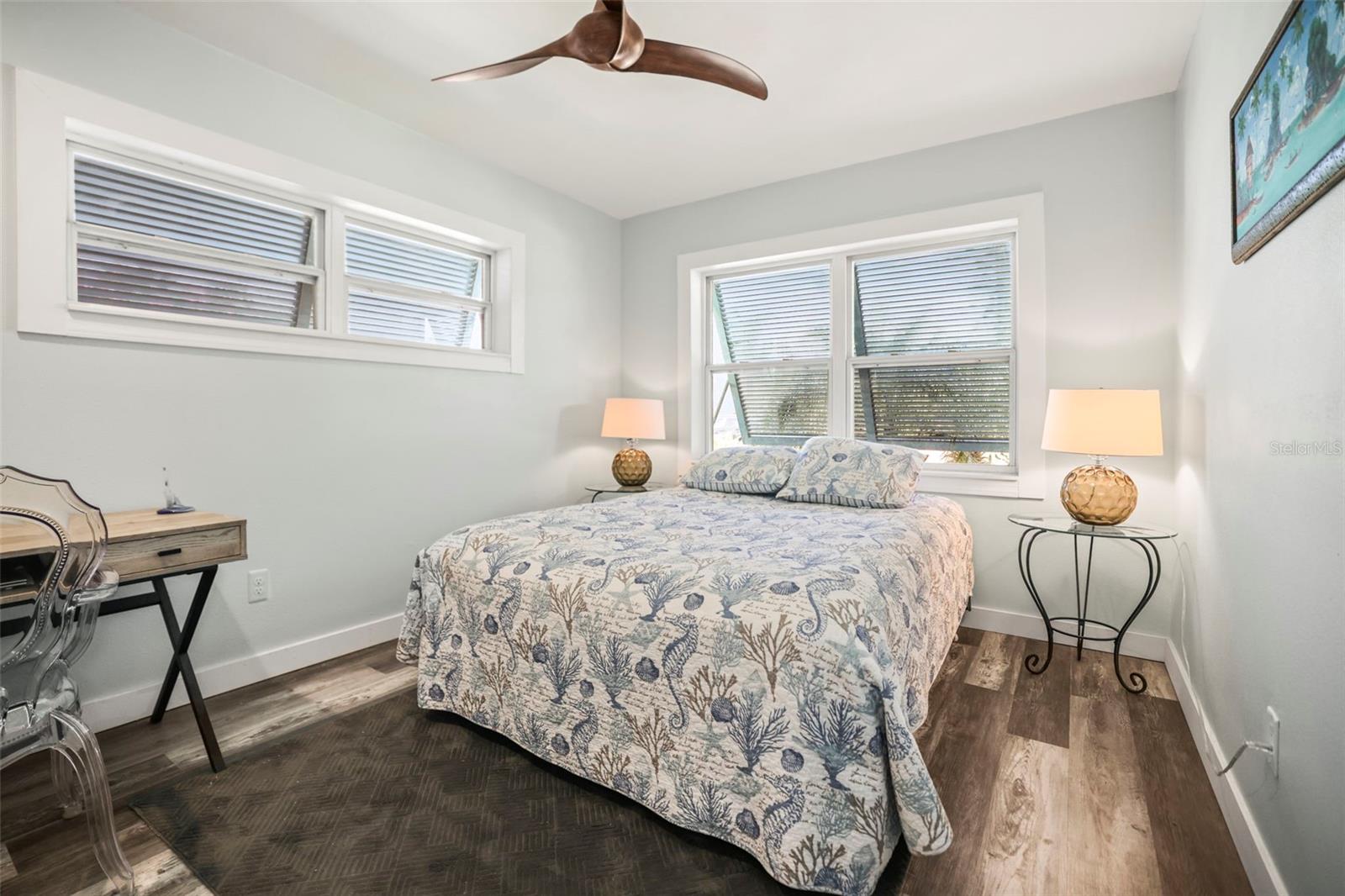 Primary bedroom with new flooring and shaded via Bahama Shutters