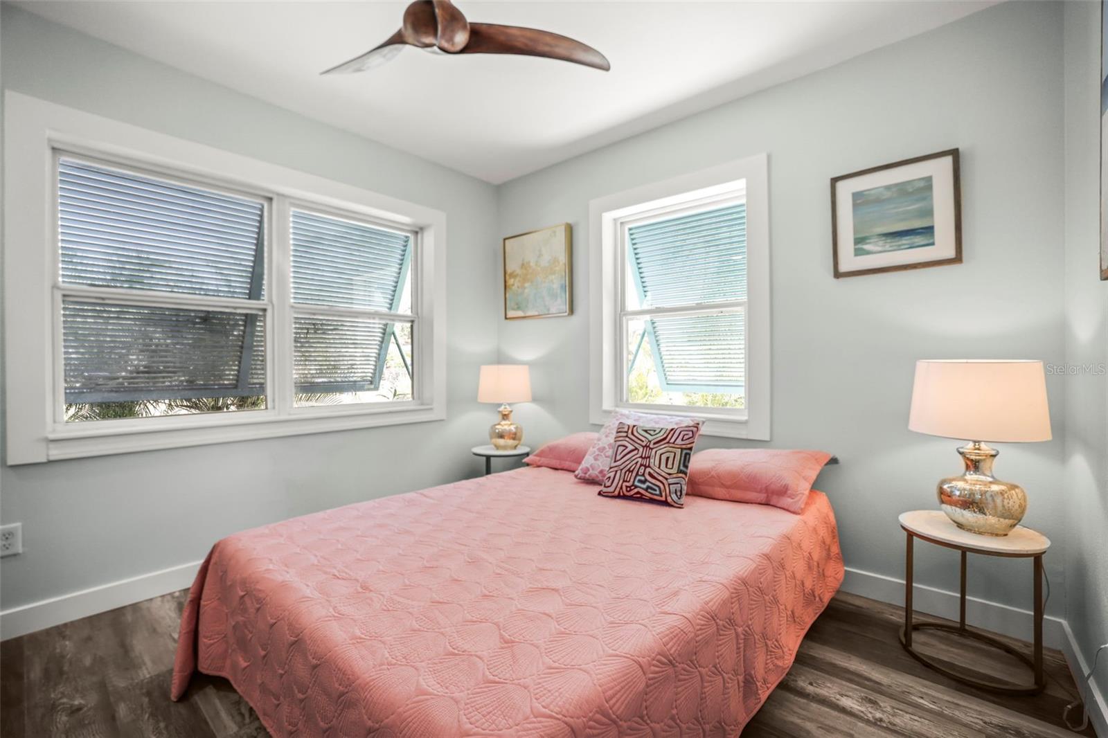 Bedroom 2 with updated flooring, freshly painted and Bahama Shutters