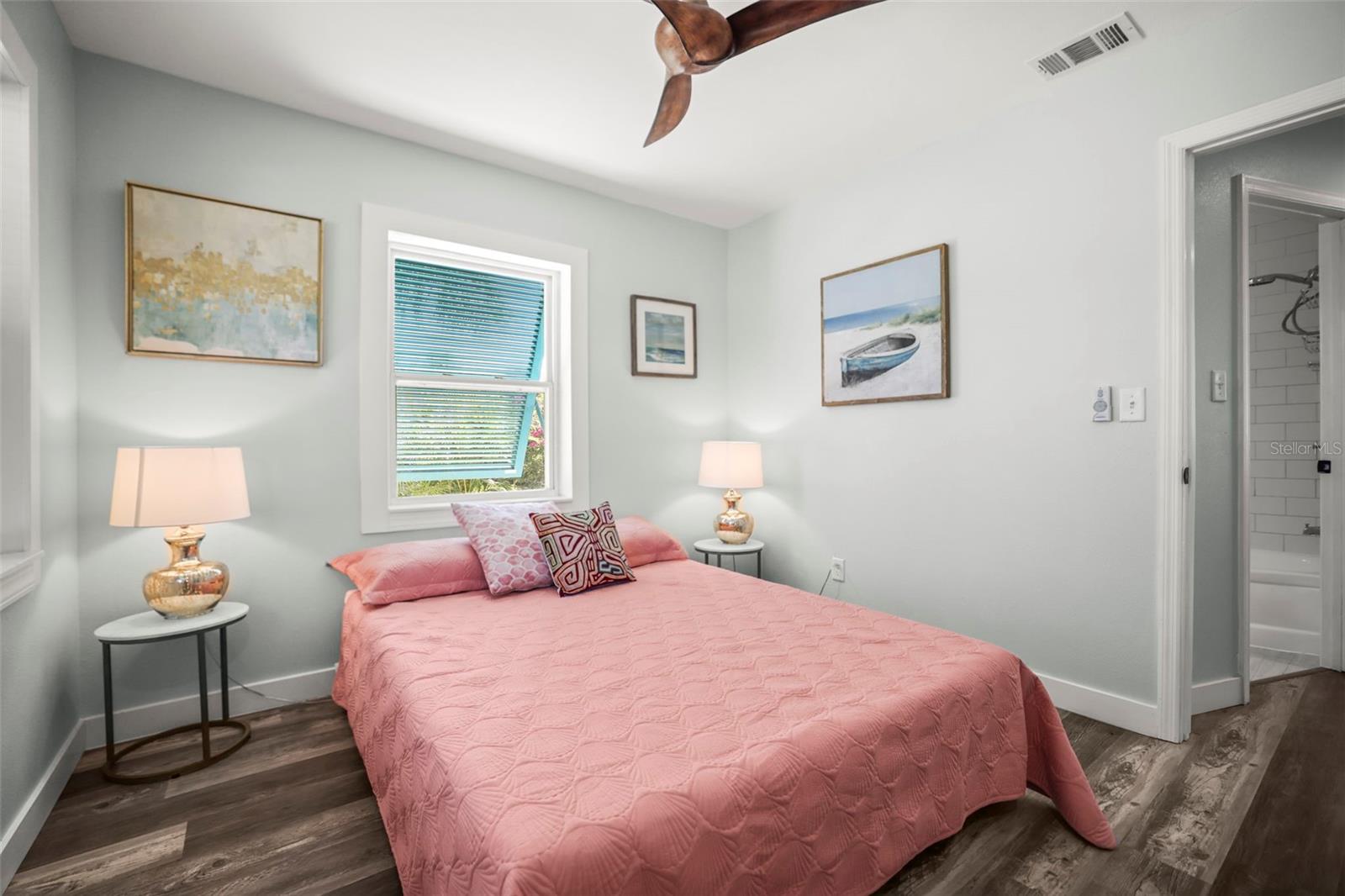 Bedroom 2 with updated flooring, freshly painted and Bahama Shutters