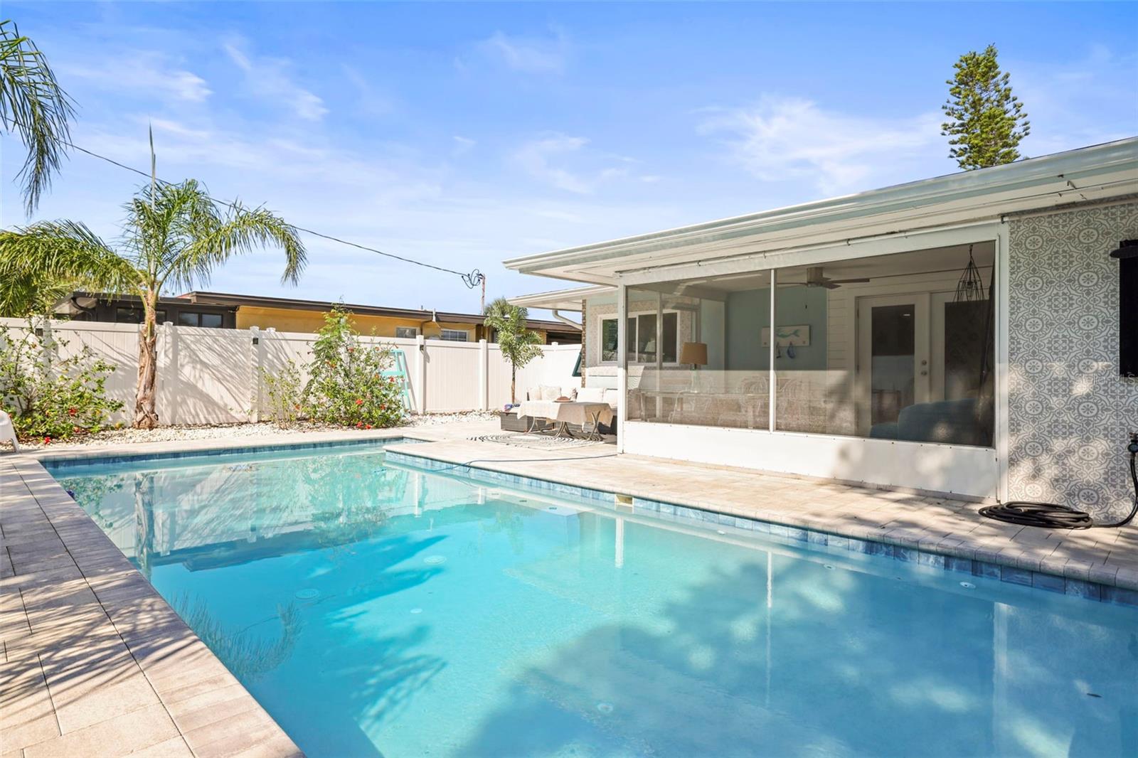 Backyard Oasis, pool, outdoor hangout, screened and covered hangout. picture yourself here.  Notice the tile wall behind the outdoor shower.
