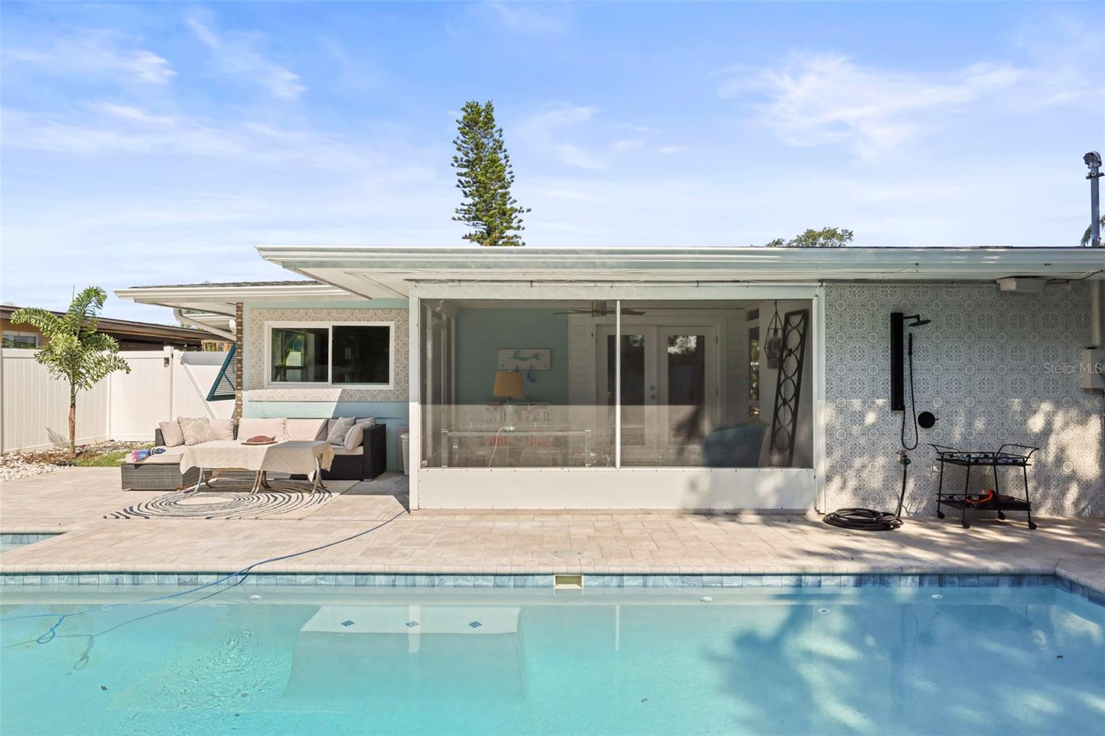 Backyard Oasis, pool, outdoor hangout, screened and covered hangout. picture yourself here.  Notice the tile wall behind the outdoor shower.