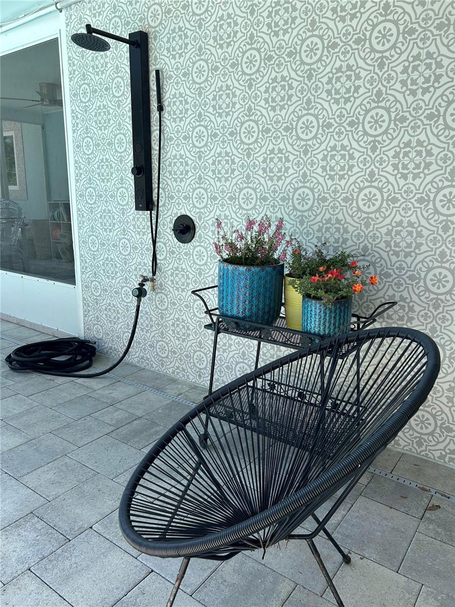 Gorgeous tile backsplash on outdoor shower. A very cool update