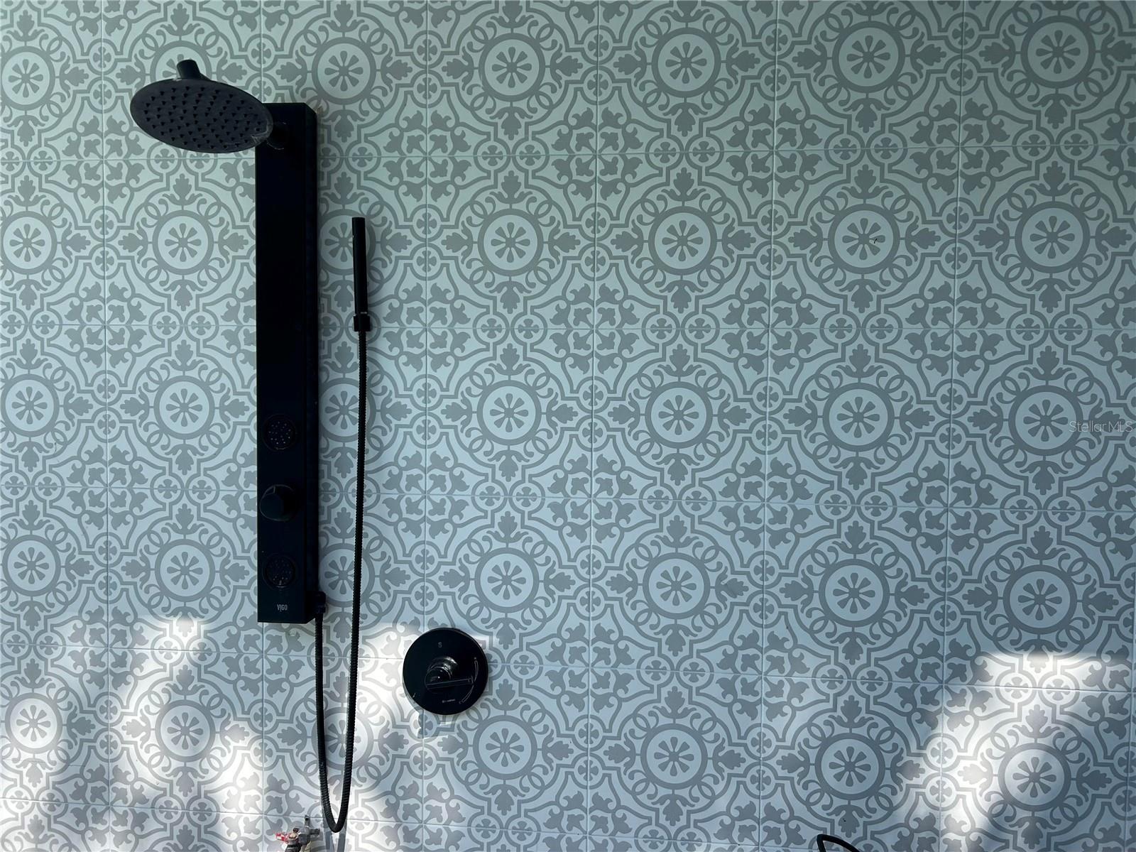 Gorgeous tile backsplash on outdoor shower. A very cool update
