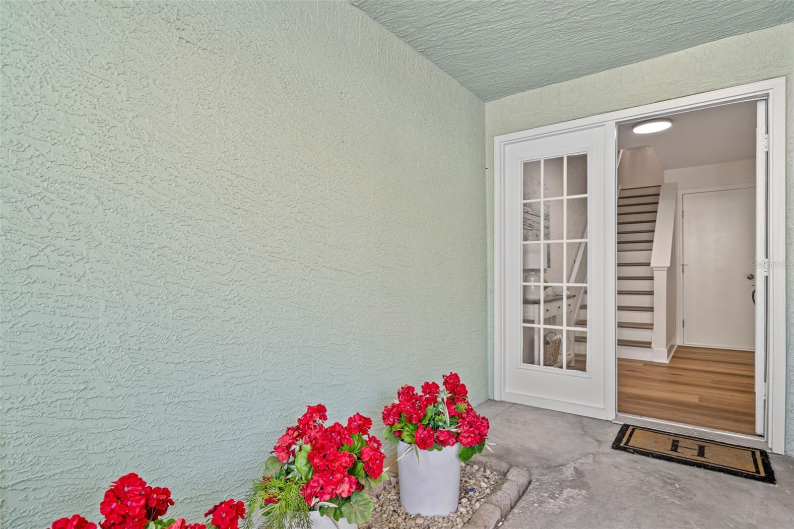 Covered front porch, front door to foyer