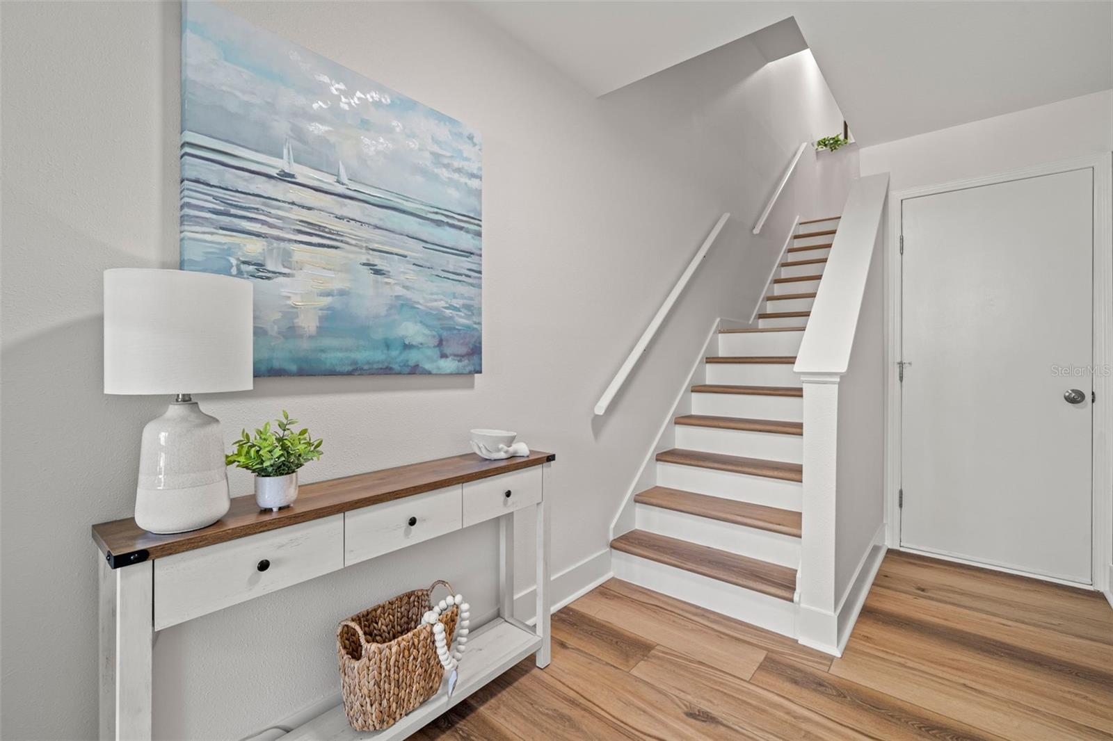 Foyer leading to stairs on left, to garage on right