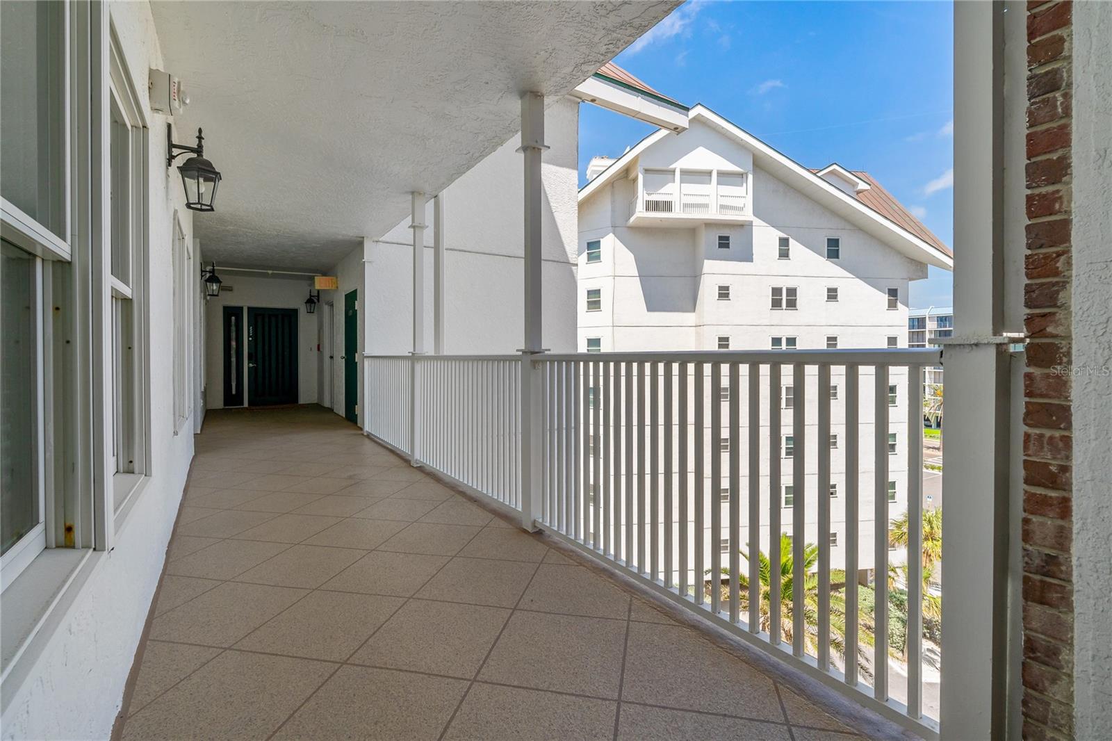 View of front balcony walkway and front of building