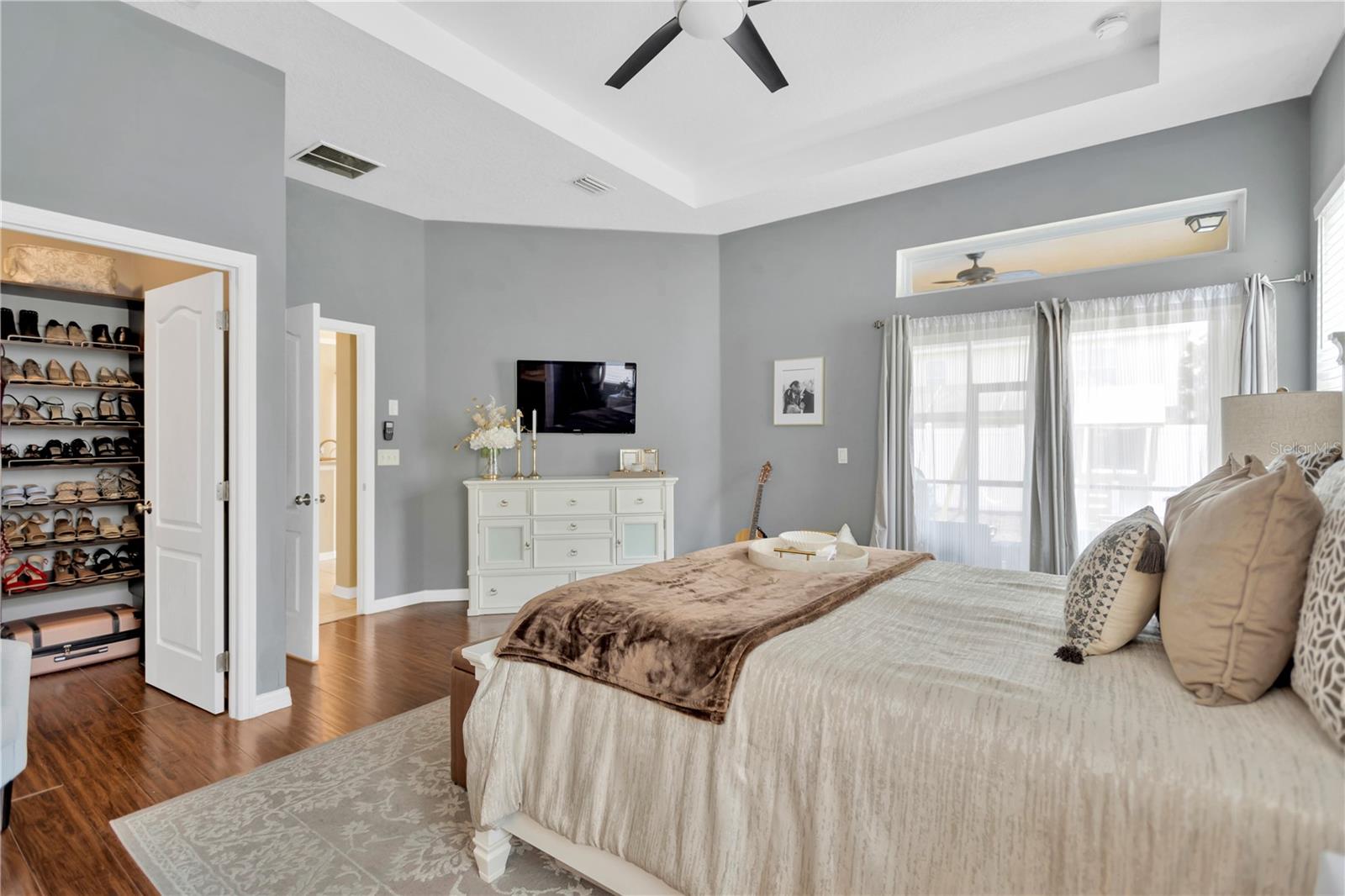 Amazing features is this large walk-in closet with organizers, tray ceiling adds a dramatic flair.