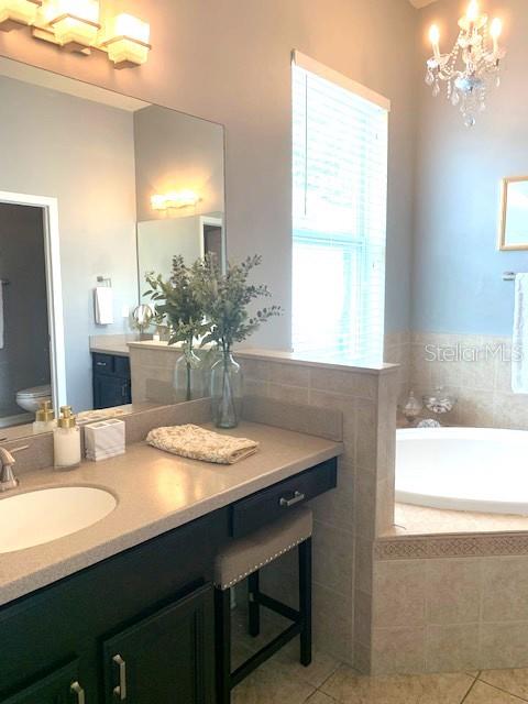 "Her" vanity with makeup area seating.