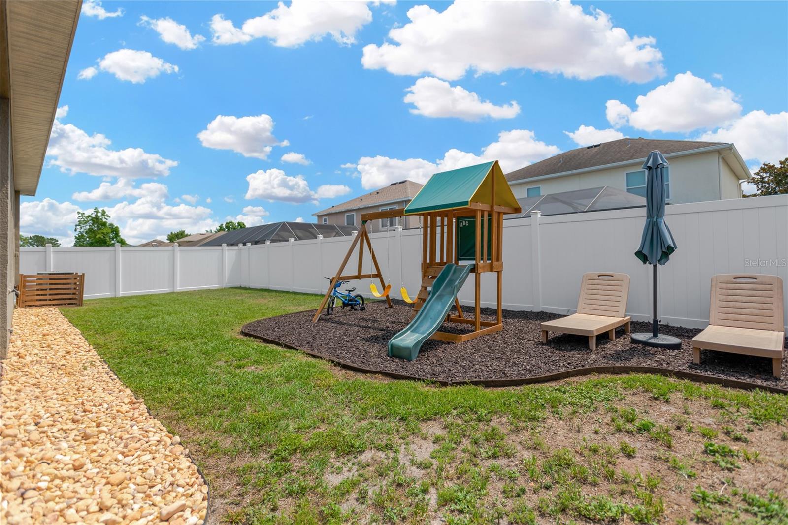 Plenty of space for a play set and lounge chairs to relax and enjoy.