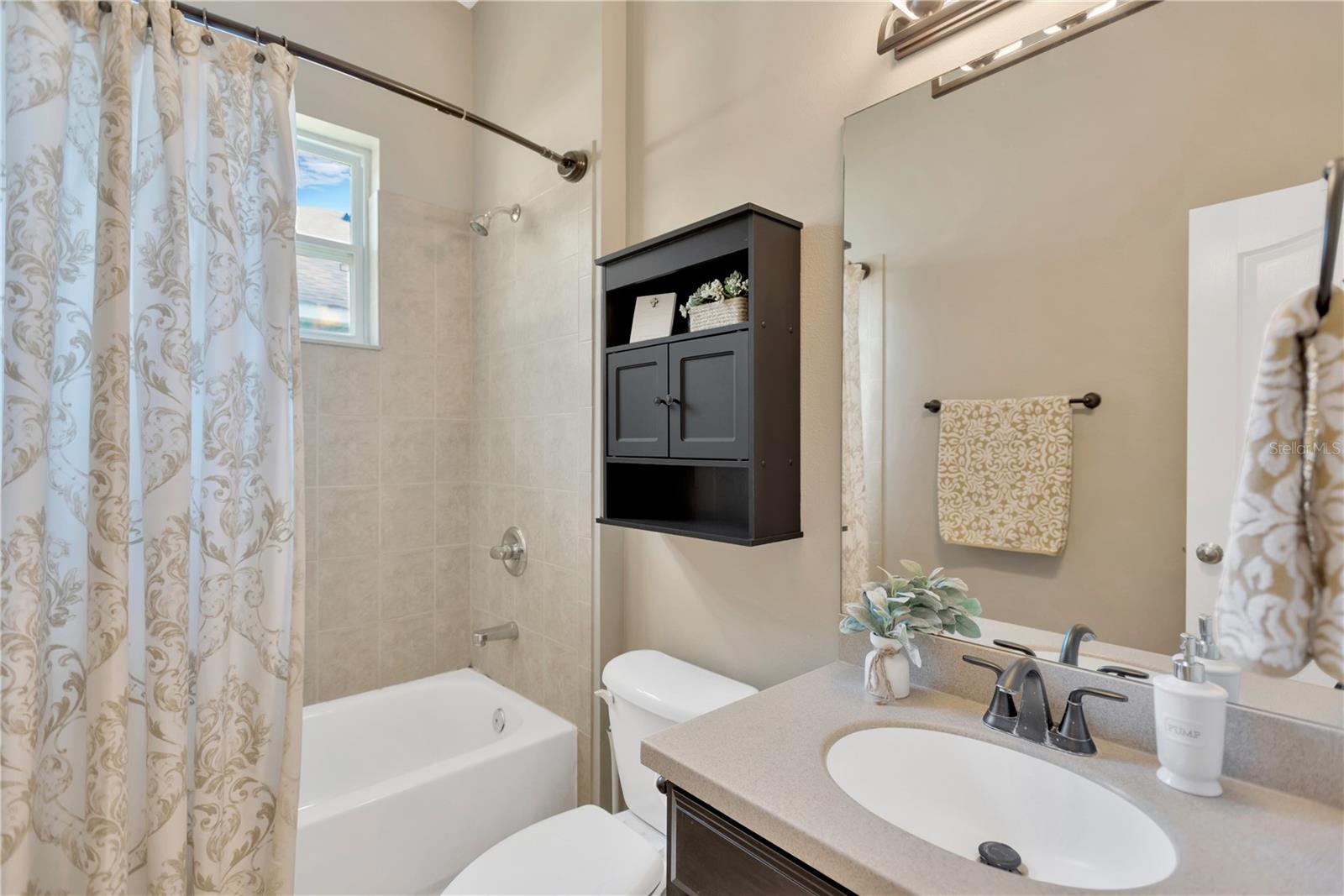 Another view of guest bathroom offers tub/shower combination.