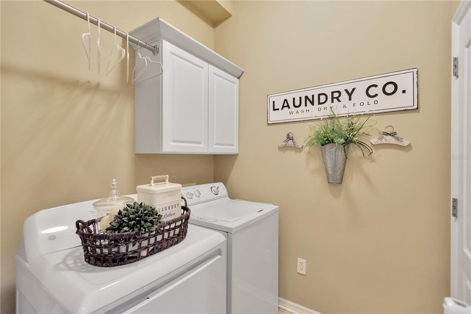 Doing laundry can be a cheerful task in this very cute inside utility area.