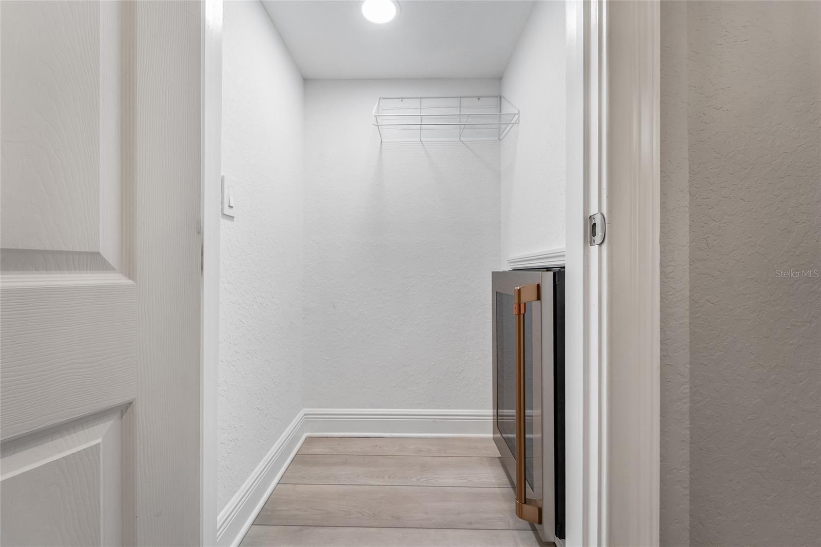 Utility closet with beverage frig.