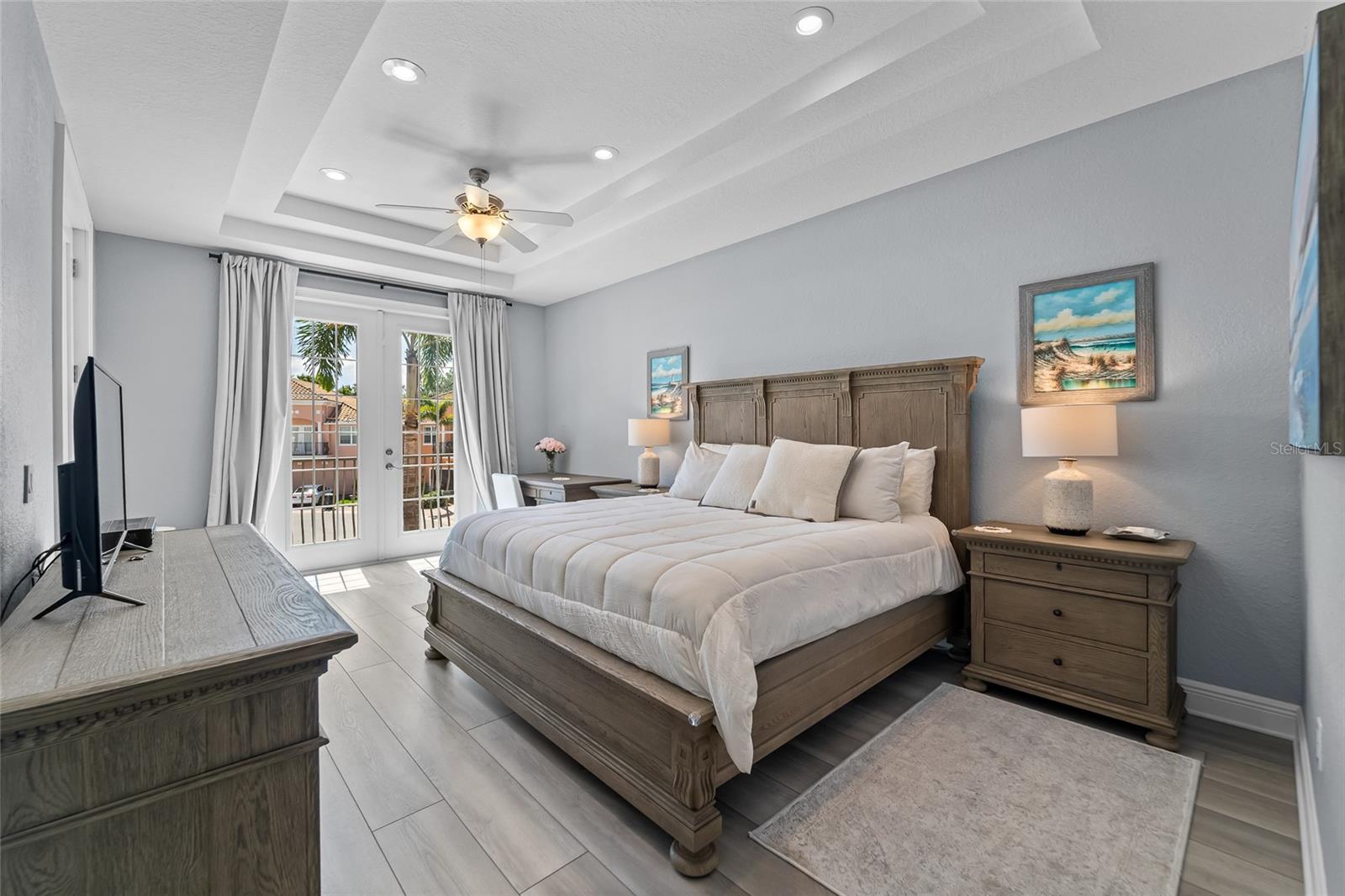 Primary suite with tray ceiling and amazing wood floors.