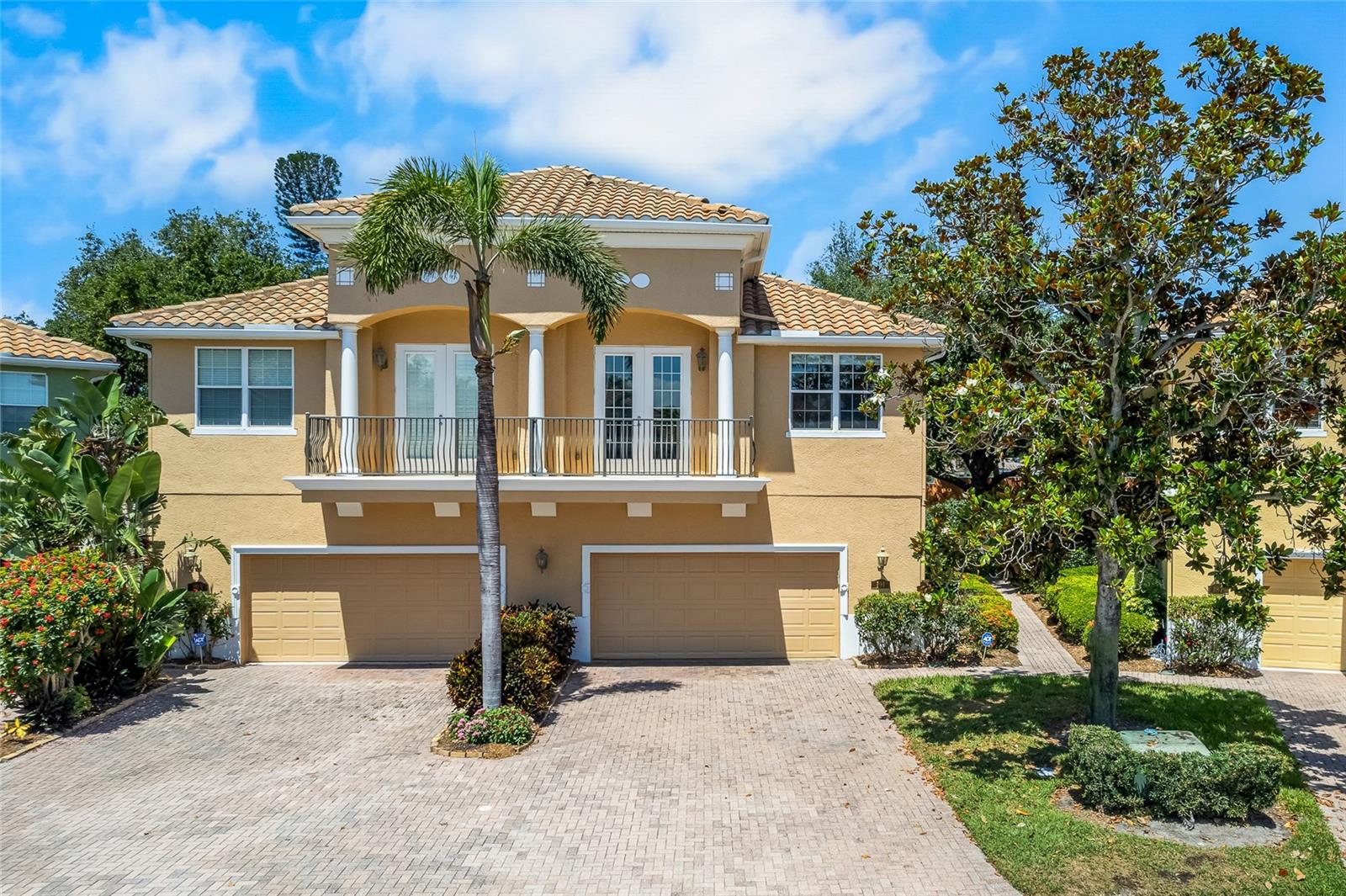 Brick drive, oversized two-car garage, private balcony.