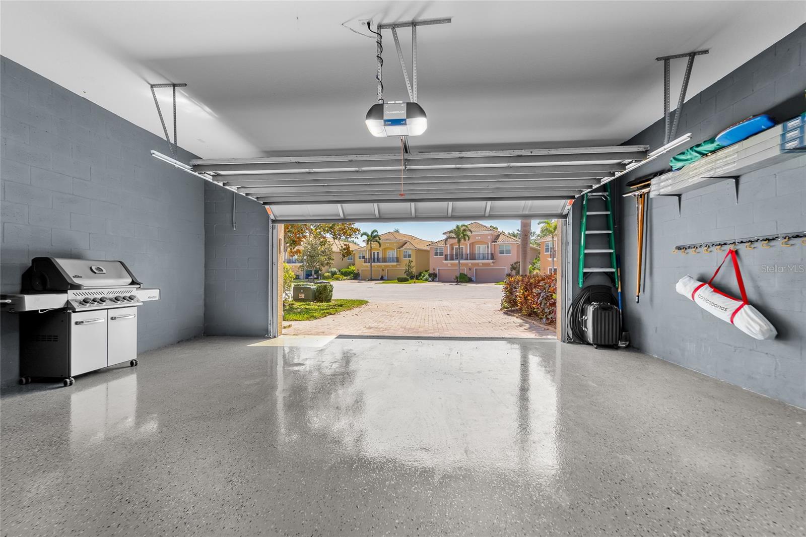 Oversized two car garage with high ceilings and epoxy flooring.