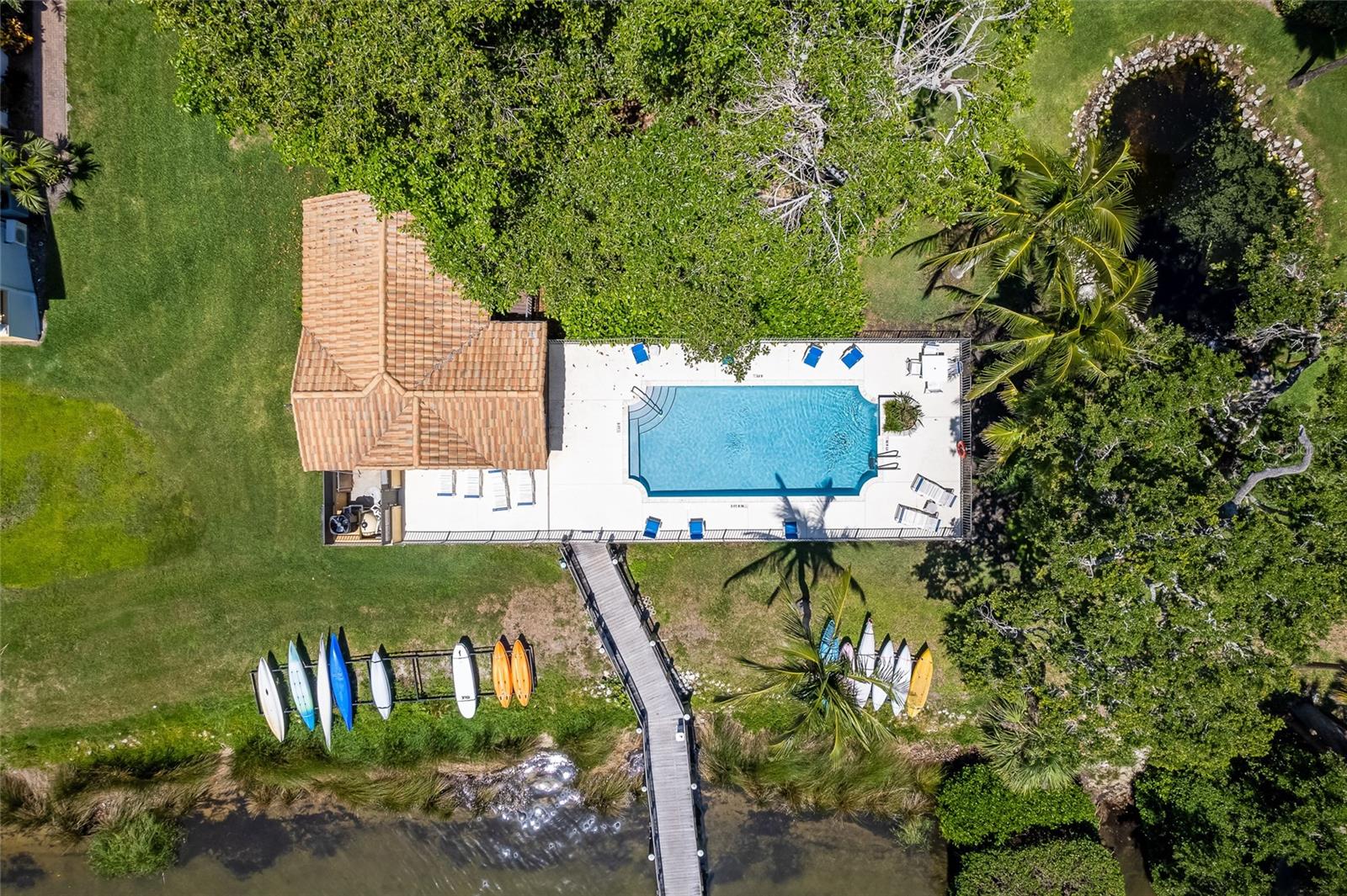 Pool, dock and kayak racks beneath the Banyan Tree.