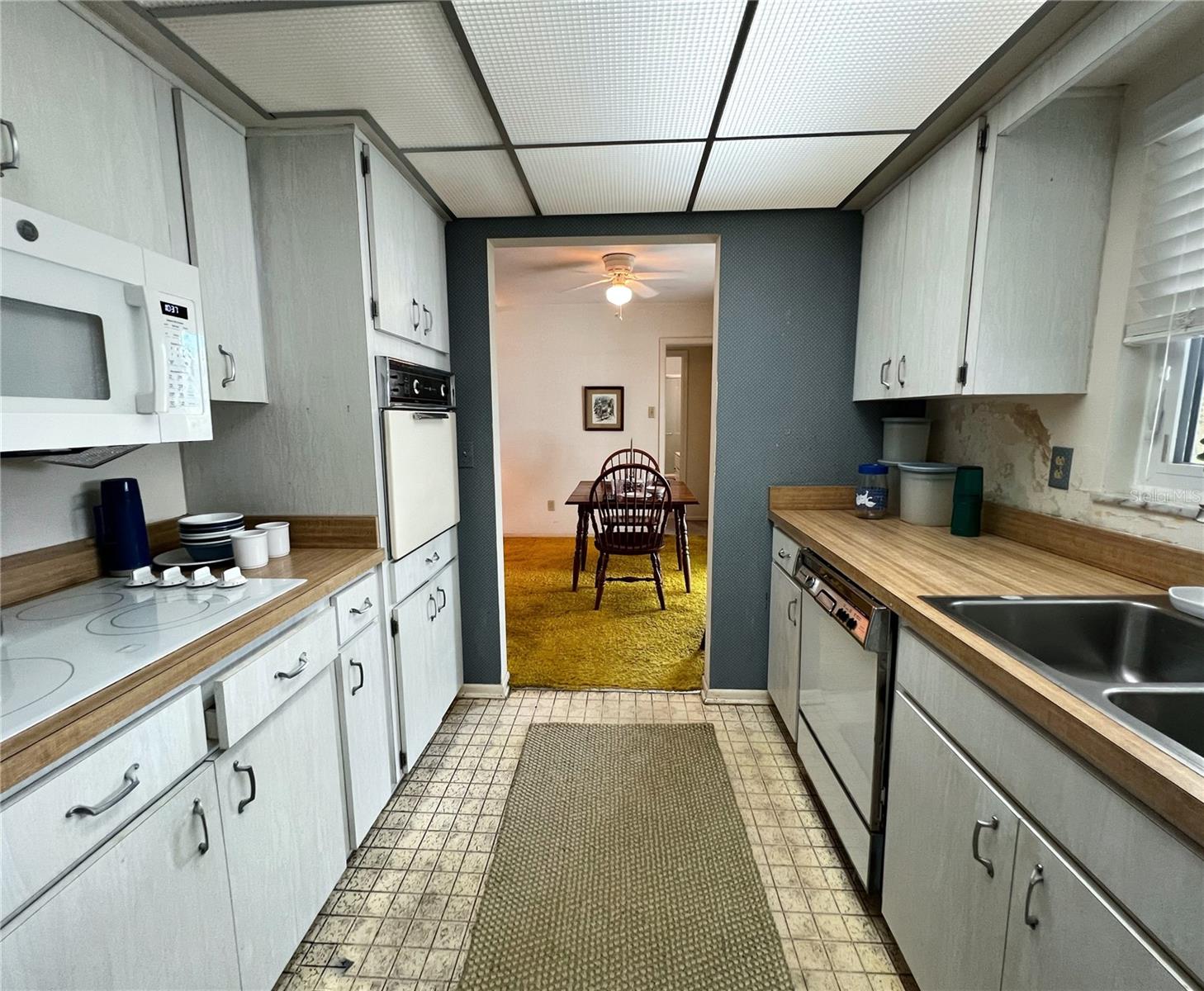 Another view of the kitchen looking towards the dining room and primary suite.