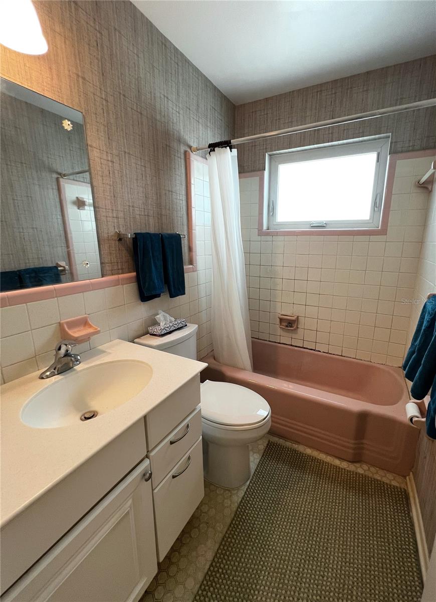 Common bathroom by the three other bedrooms with a tub/shower combo.