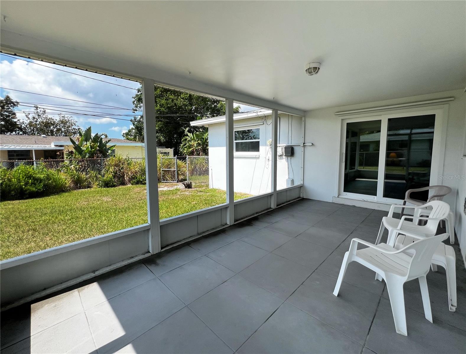 Spacious porch overlooking the fenced in yard.