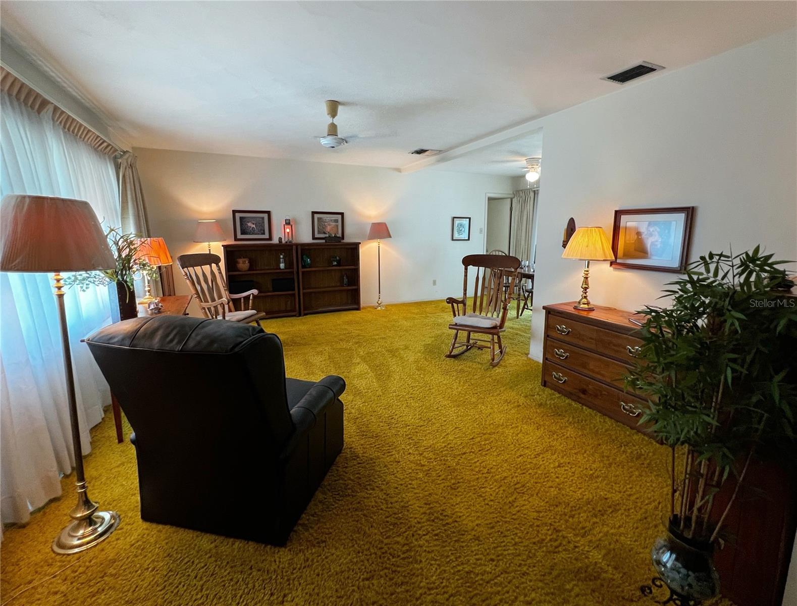 Front entrance into this spacious home into the large living room. Terrazzo flooring under the carpet!