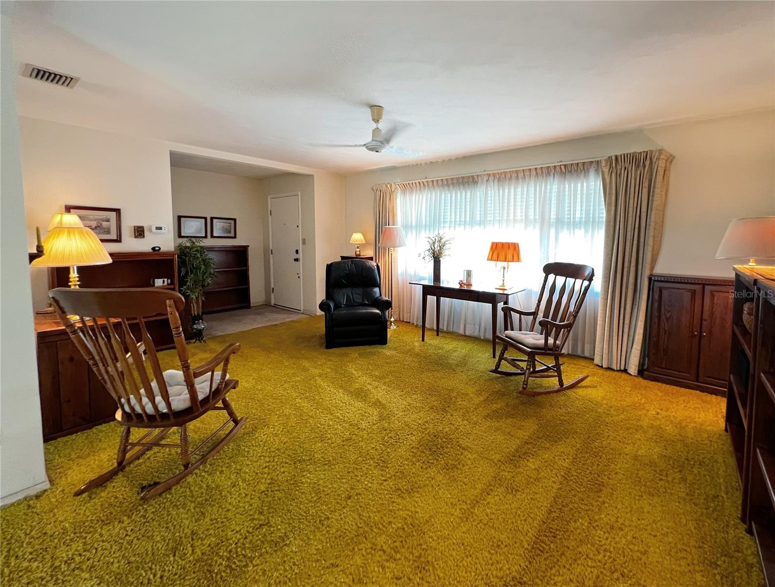 Another view of the living room at the front of the home, and the front entrance door.