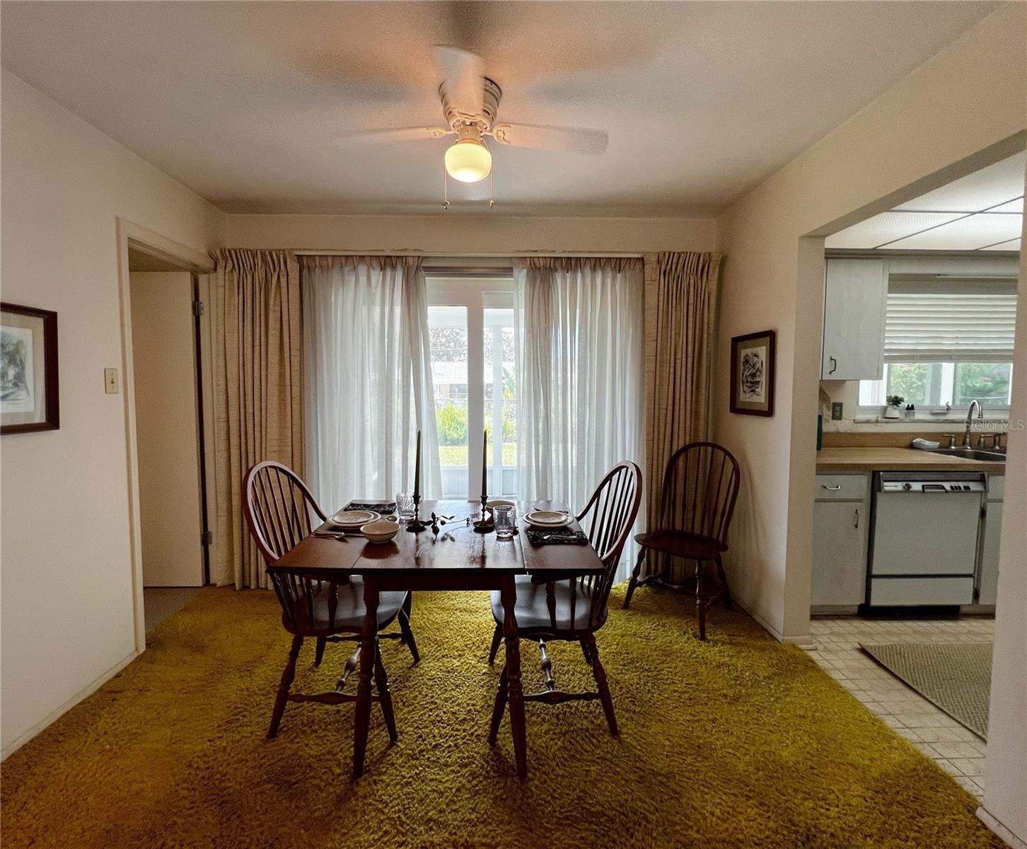 Dining room off the living room and kitchen, plus sliding glass doors to access the screened in porch.