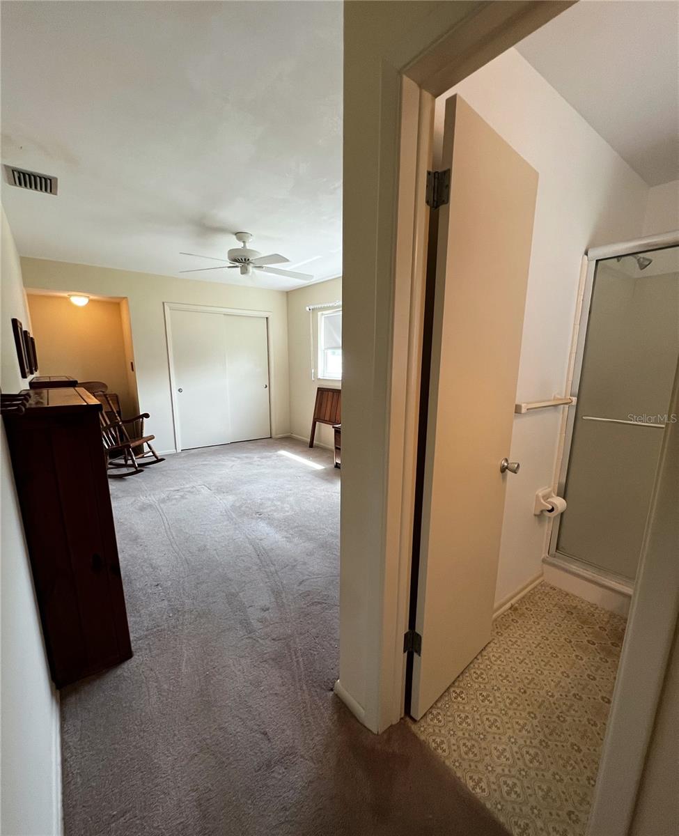 Entrance into the Primary Suite with attached private bathroom. This room is on a separate side of the home- by the dining room.
