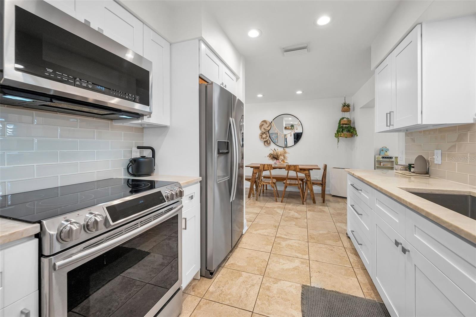 Quartzite Countertops, Subway Tile backsplash and Maple cabinets