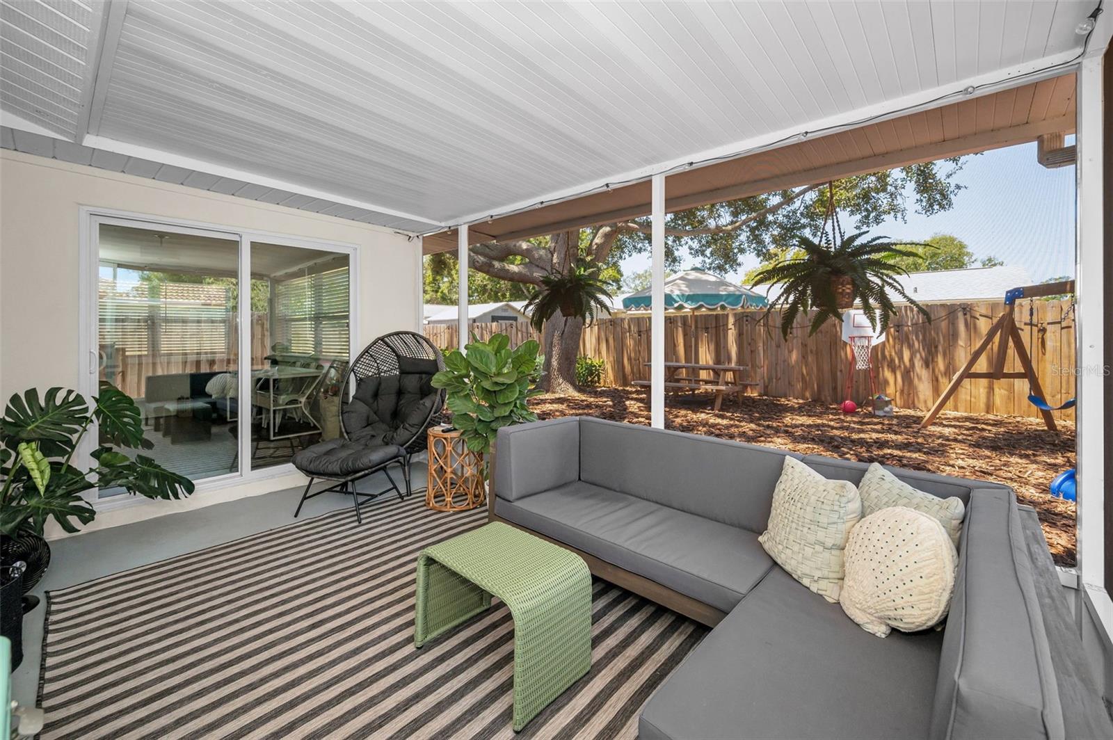 Covered Lanai overlooking the fenced yard