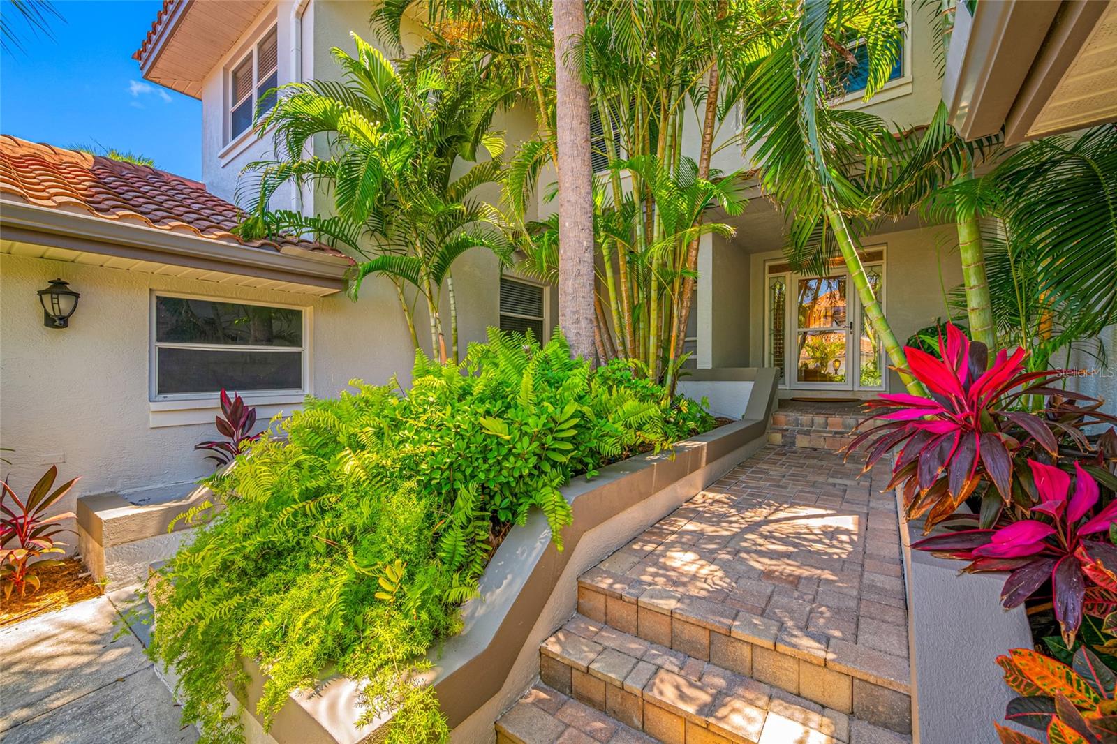 Private, tropical walkway to front entry