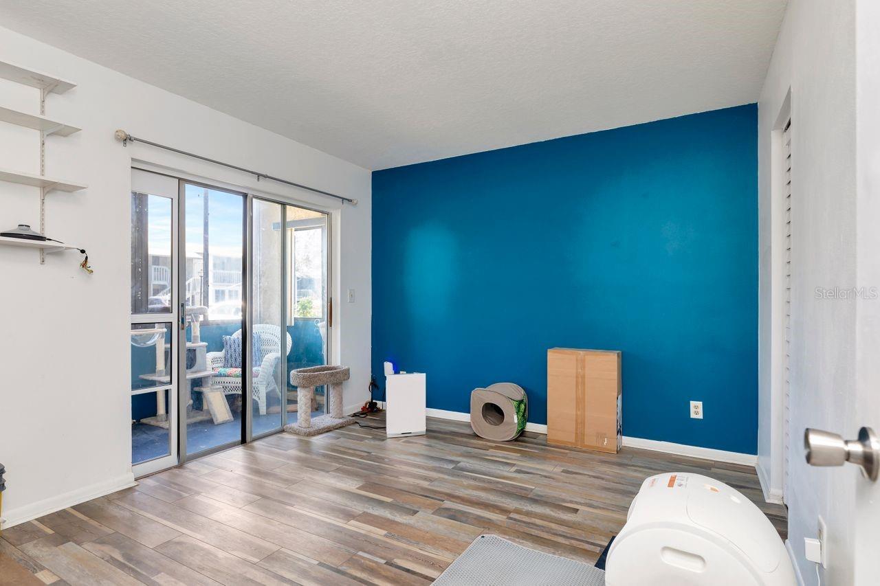 Second bedroom offers an enclosed porch with plenty of natural light and a spacious closet.