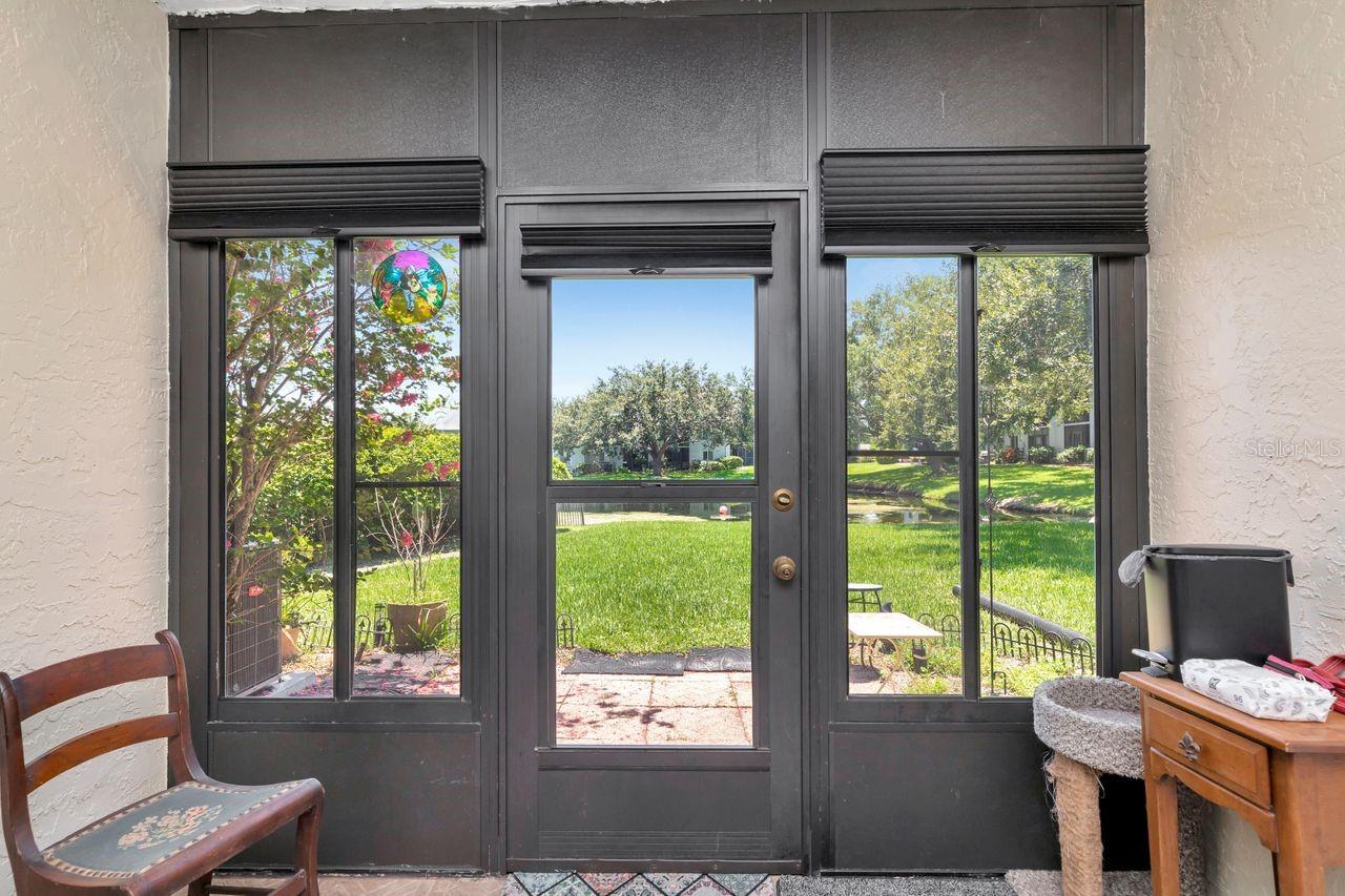 This enclosed rear patio offers a beautiful view of the lake while enjoying the benefits of air conditioning!