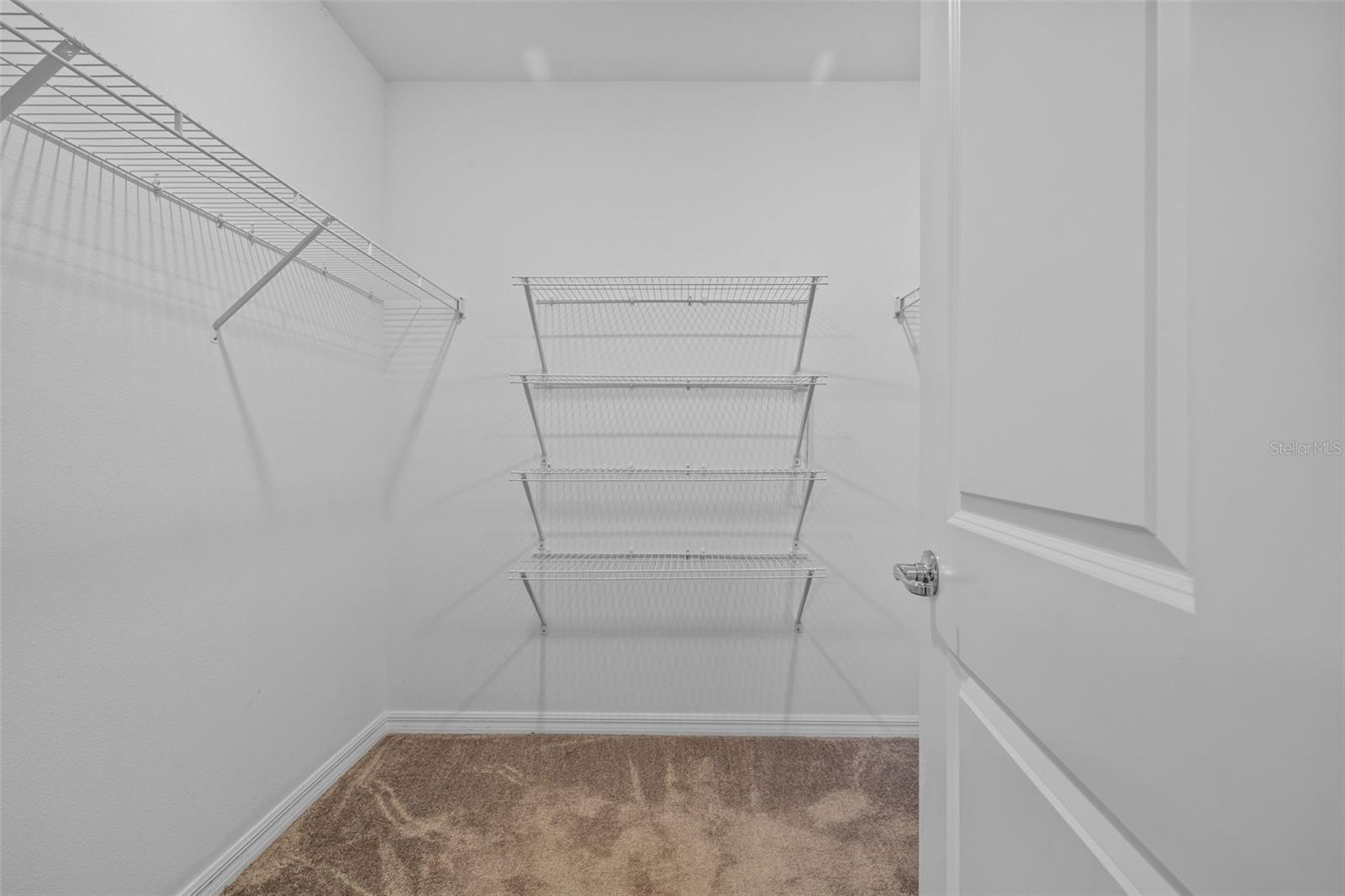 Primary bedroom walk-in closet