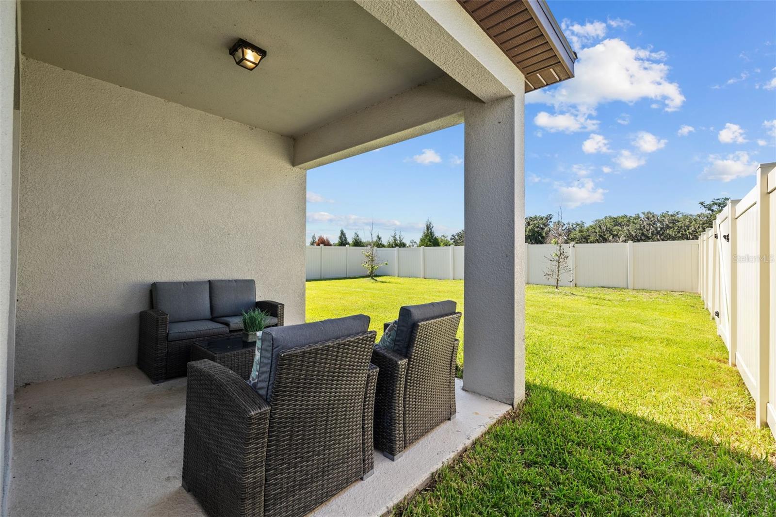 Back patio with view of fenced in back yard