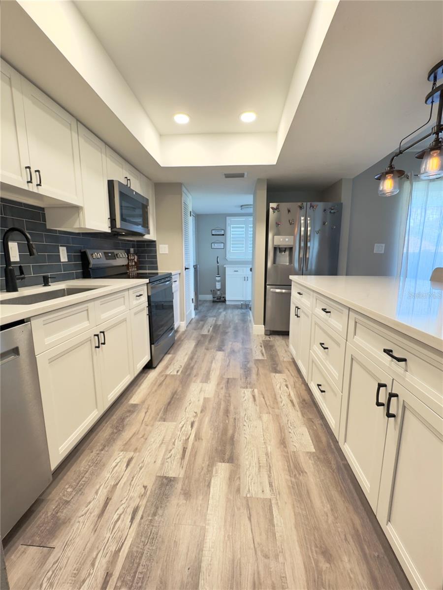 kitchen leading to laundry room area