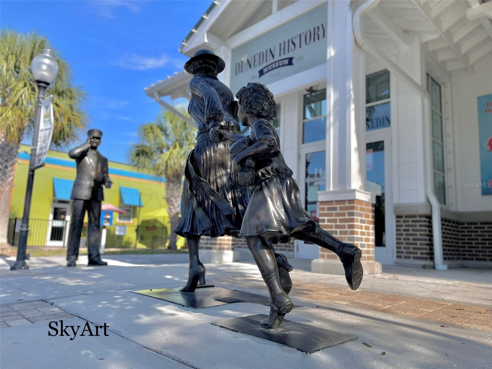 Train Station conductor calling Mother with her daughter.  One of the most sought after picture moments in Dunedin.  The Donor, a former Trustee of the Dunedin History Museum, wanted her face on the Mother statue.
