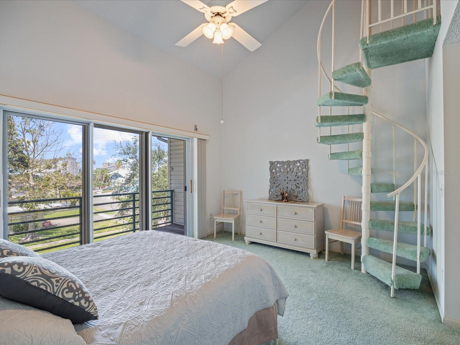 Primary bedroom with stairs to loft