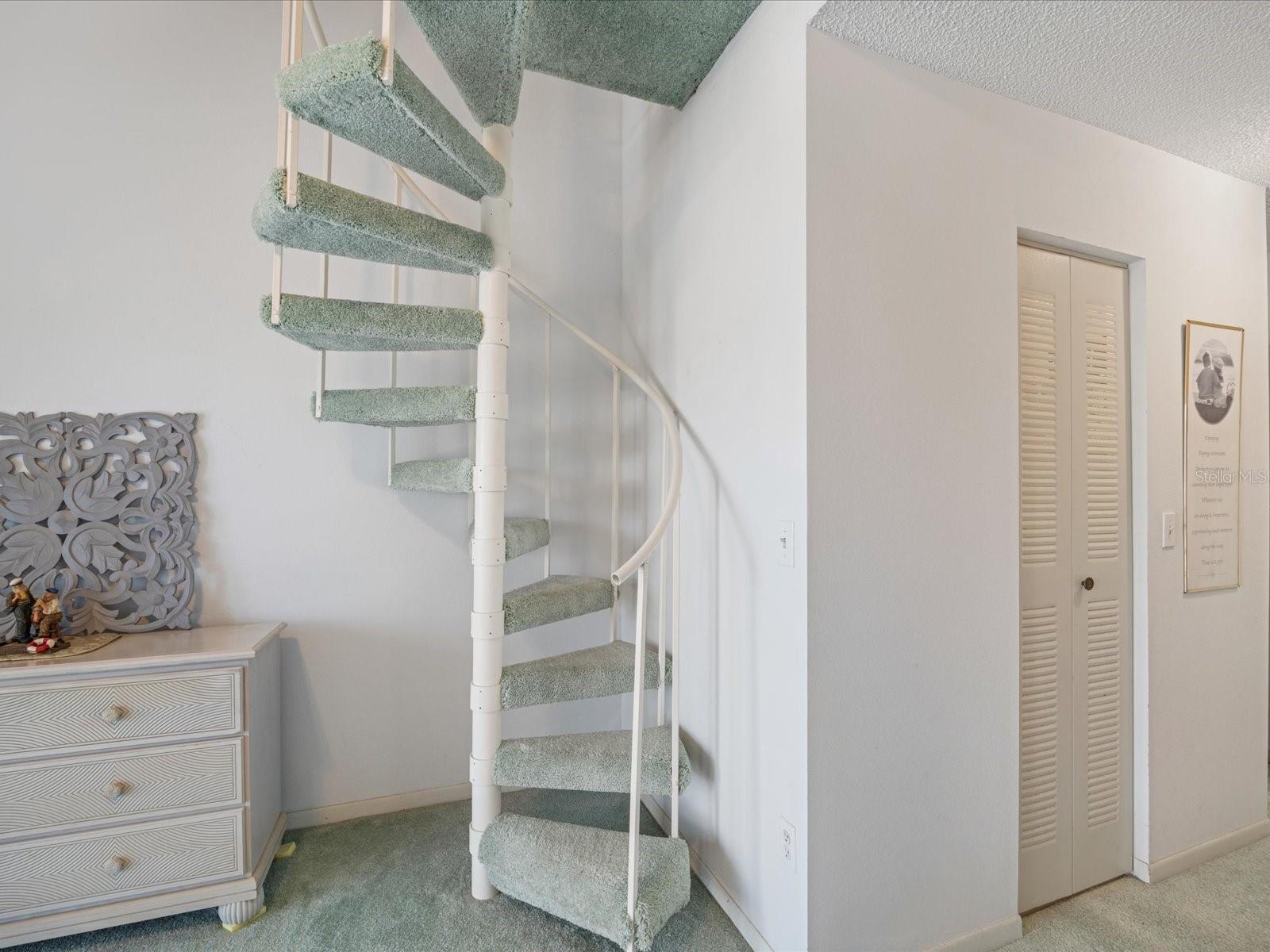 Spiral staircase leading up to loft