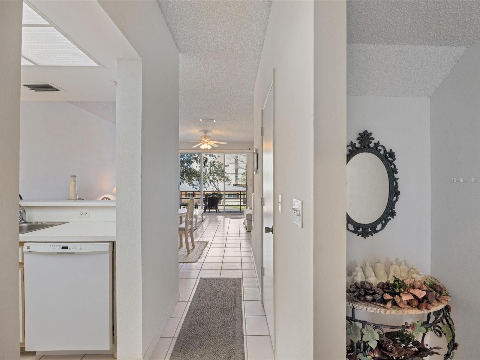 2nd floor hallway with kitchen on left and living room straight ahead