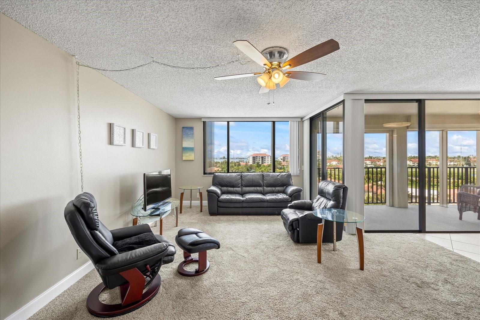 Large windows with golf course views and beautiful water in the distance!