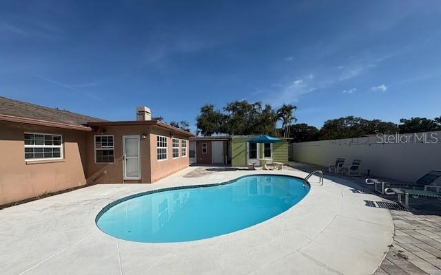 Back Exterior with pool and new pavers and storage