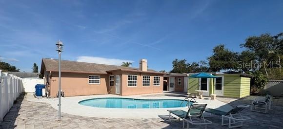 Back Exterior with pool and new pavers and storage