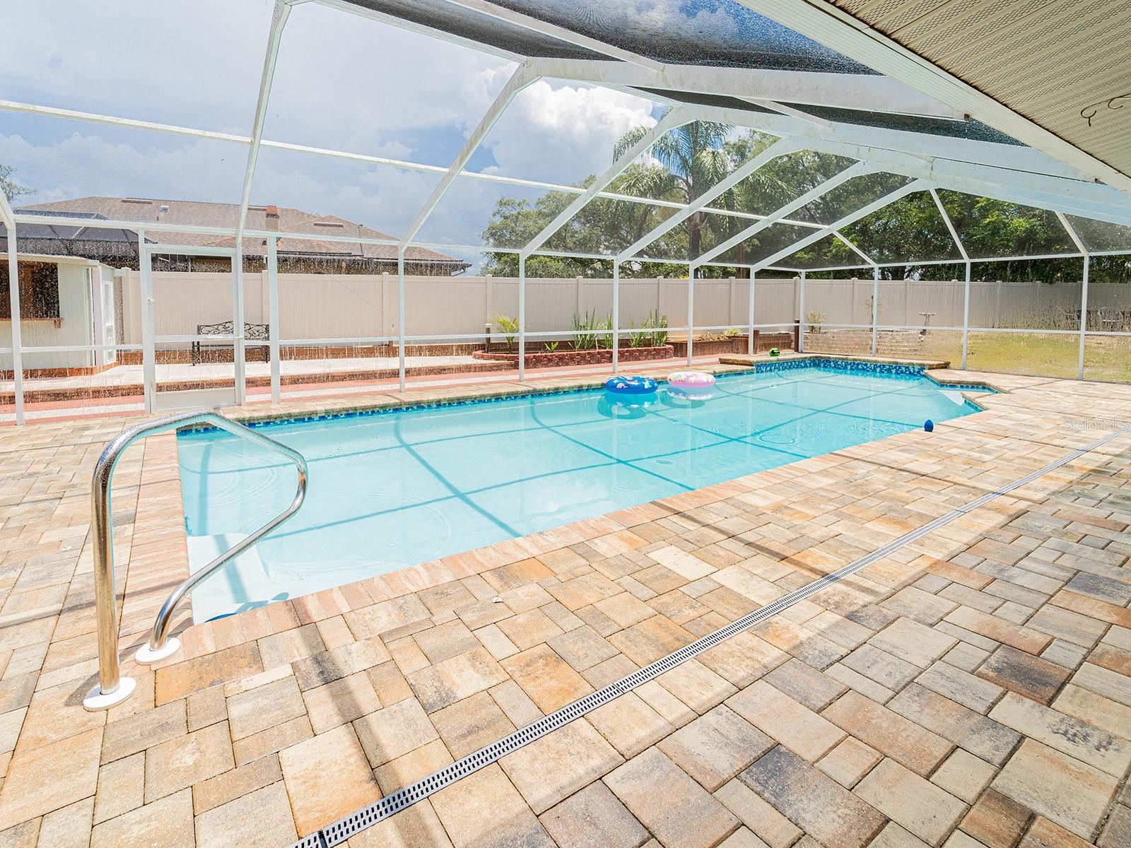 Enclosed Pool with decorative pavers