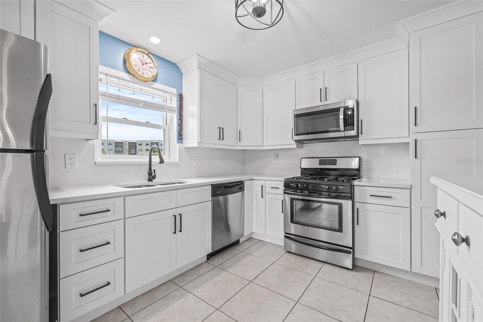 Updated kitchen with soft closing cabinetry and quartz countertops.