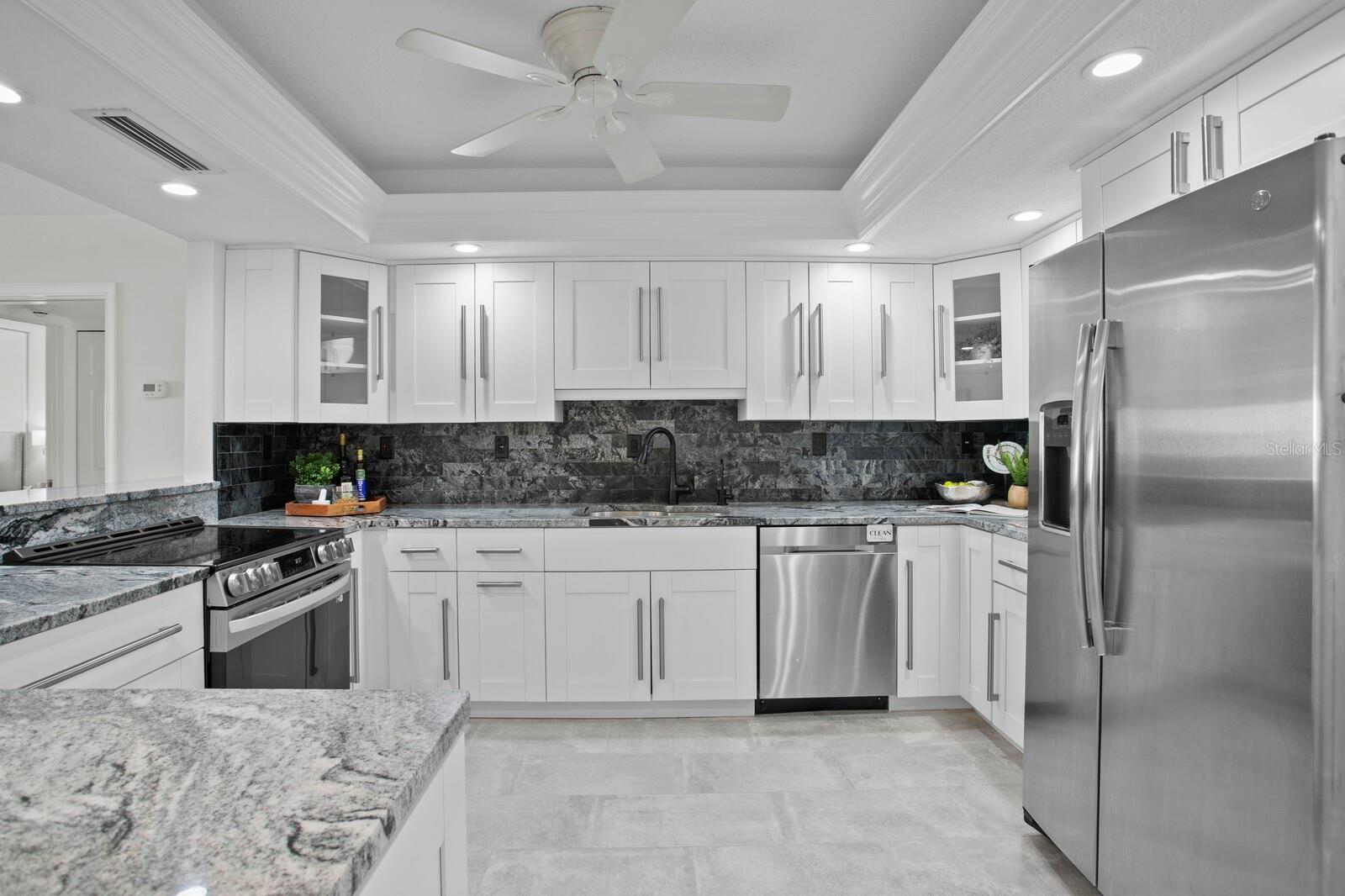 The kitchen has clean lines, sleek granite, and an awesome  layout. https://player.vimeo.com/video/1087835561