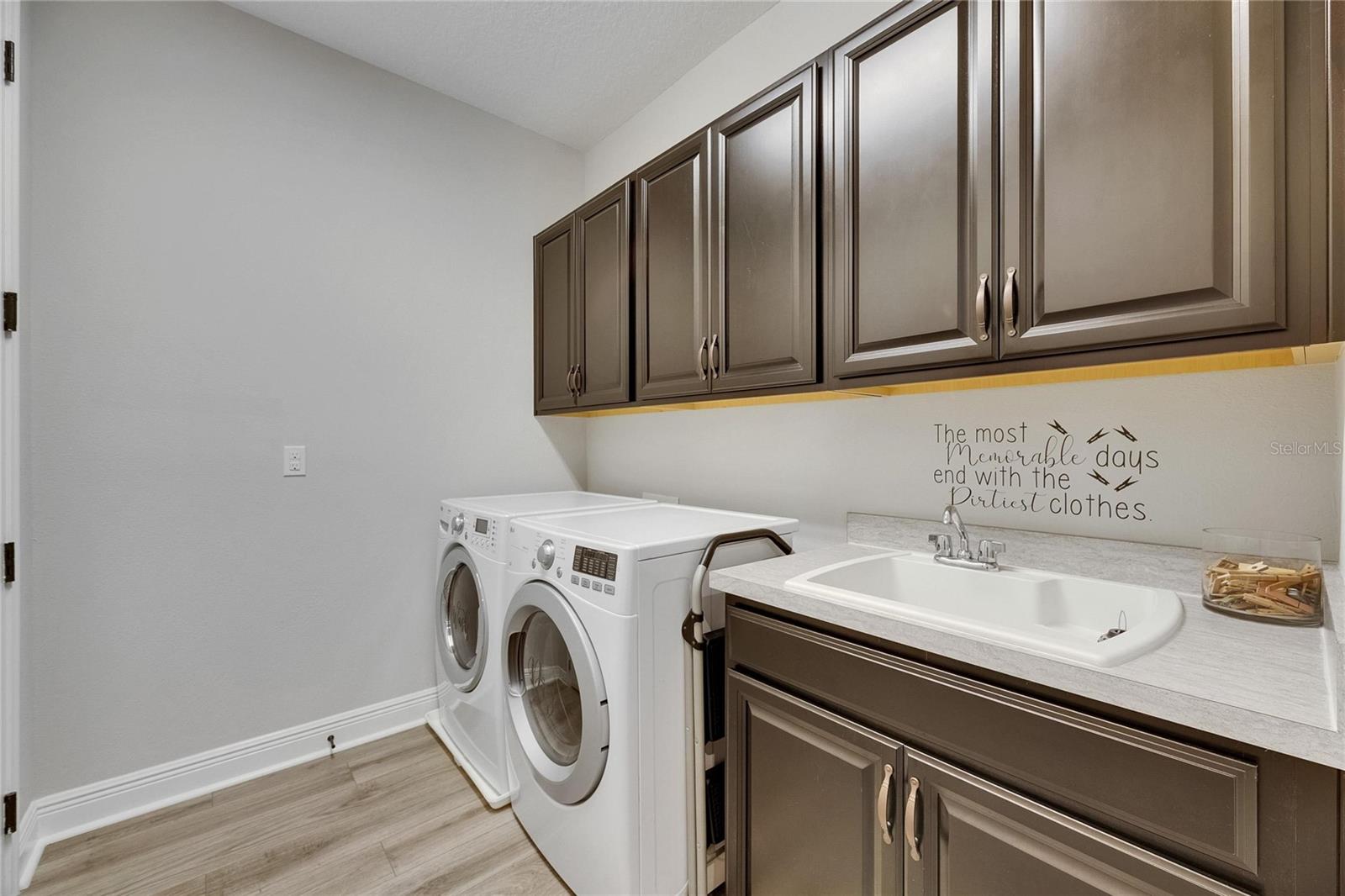 Laundry Room with Cabinetry and Utility Sink