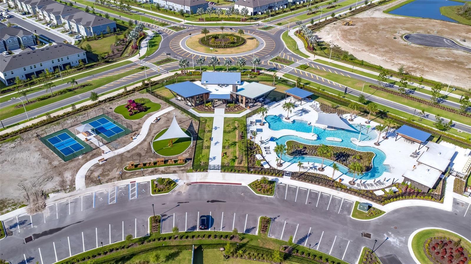 Aerial of the lazy river, pool, amenity center.