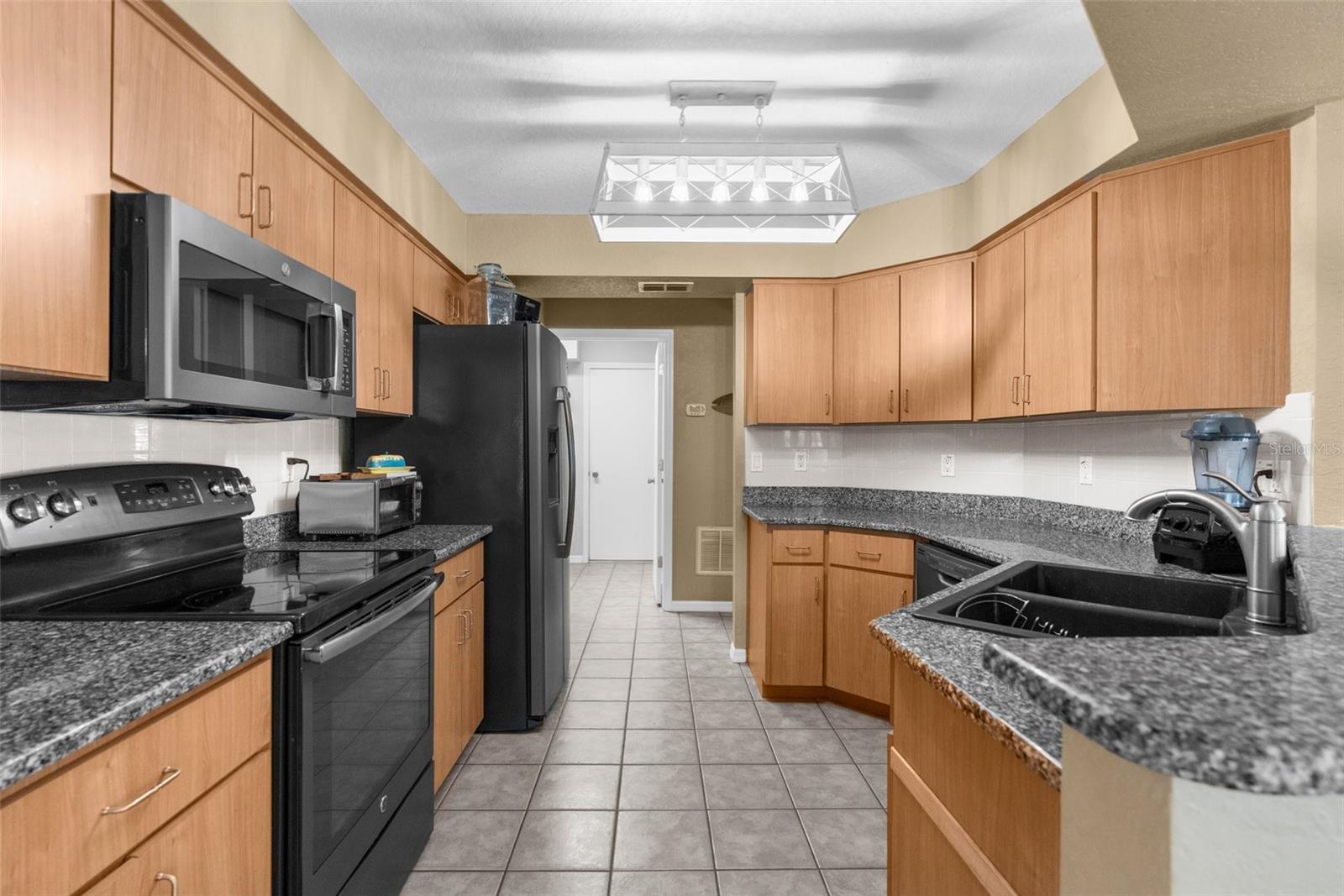 granite counters, black stainless steel appliances