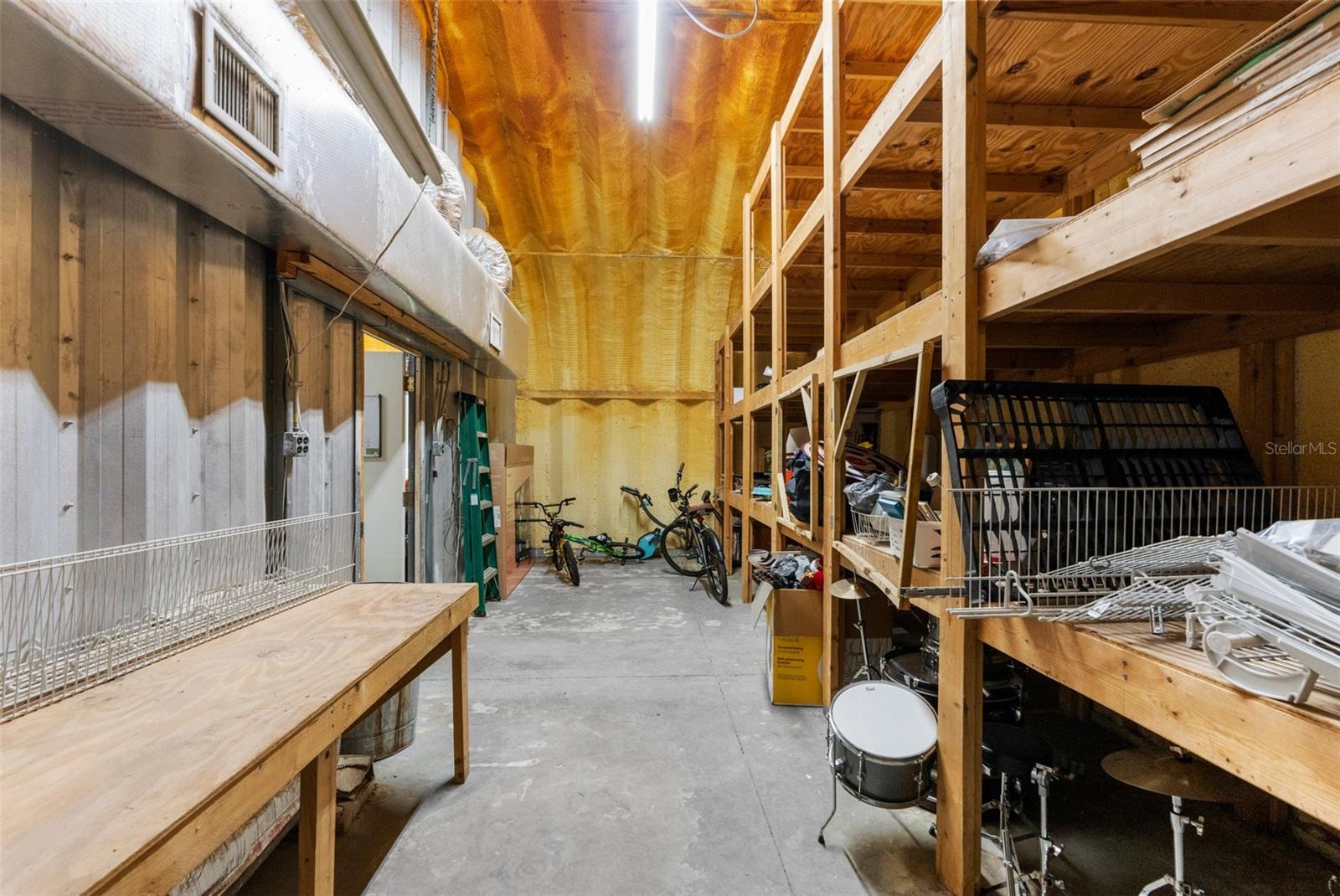 workshop table with ceiling to flooring shelving