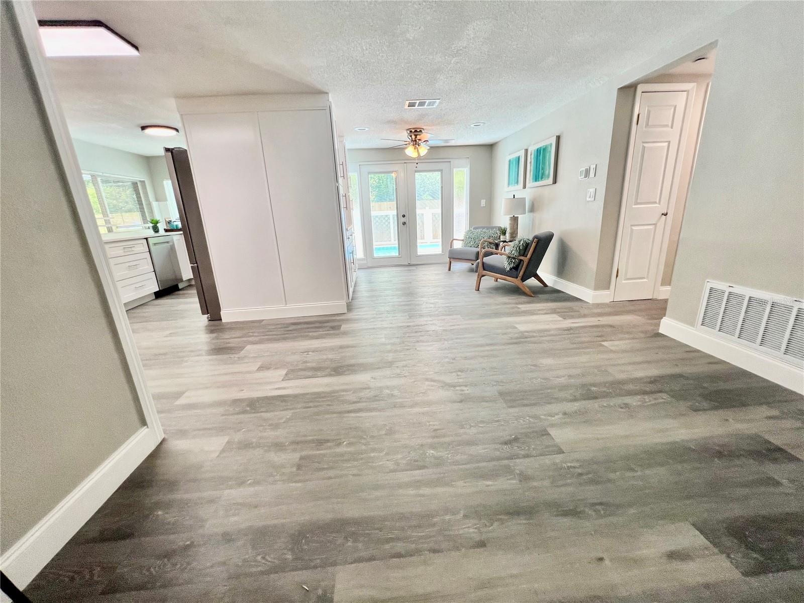 VIEW FROM ENTERANCE TO FAMILY ROOM AND KITCHEN